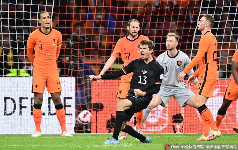托马斯·穆勒进球后紧握双拳，在阿姆斯特丹的夜空下激情怒吼庆祝