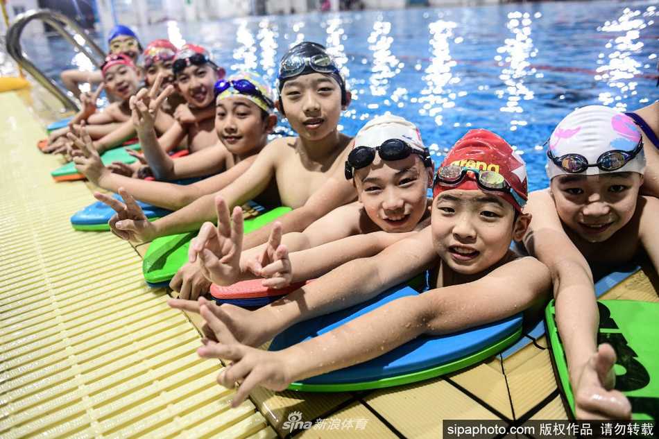 训练间隙，一名少年运动员趴在泳池边，认真聆听教练的指导。他湿漉漉的头发贴在额前，清澈的目光中透着一股不服输的韧劲和对未来的无限憧憬。