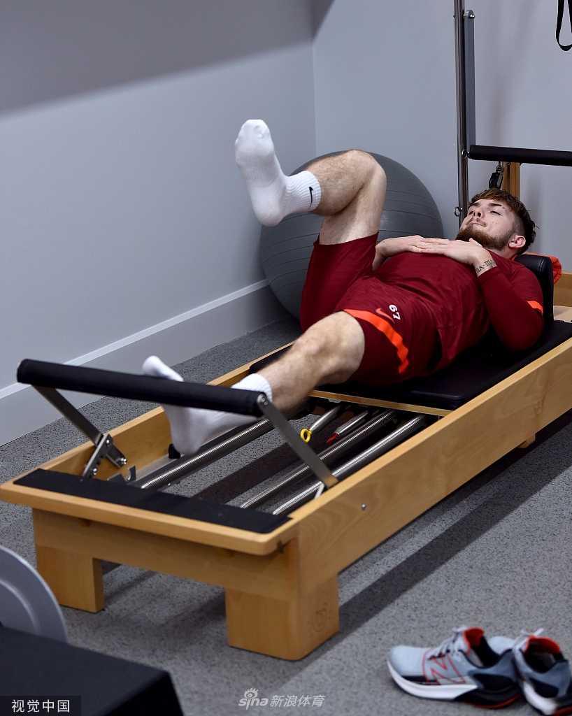 在科克比基地的室内训练房里，哈维·埃利奥特神情专注，双手紧握着弹力带进行力量训练，眼神中透露出渴望回归赛场的坚定光芒。