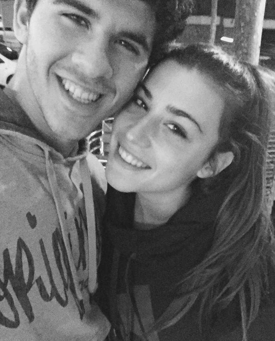 午后的咖啡馆角落，两人穿着简约的情侣装，头靠着头看向镜头，眼神里满是只有年轻情侣才有的清澈爱意和对未来的无限憧憬。