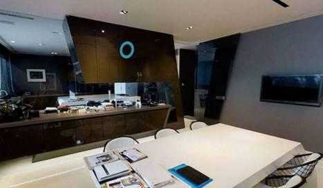 客厅内，温暖的阳光透过巨大的落地窗洒满整个空间，高级灰的沙发与黑色石板墙面相得益彰，展现出主人低调而高雅的生活品味。