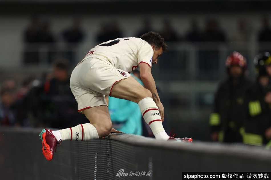 弗洛伦齐手持AC米兰球衣，在米兰内洛训练基地展示自信微笑