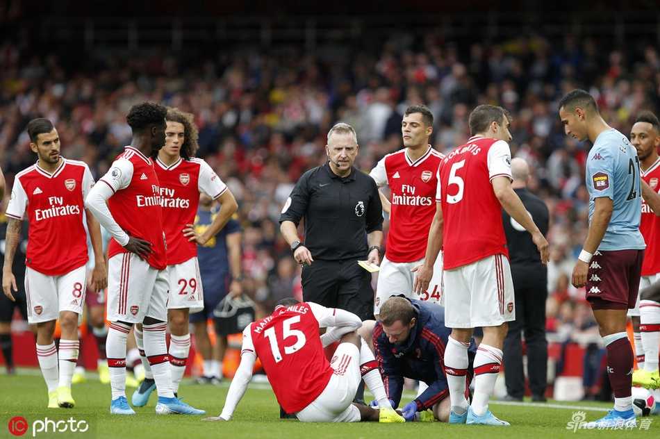 奈尔斯飞铲瞬间自己受伤倒地，表情痛苦，身旁的维拉球员也翻滚在地，主裁判的手已伸向口袋准备出示黄牌。