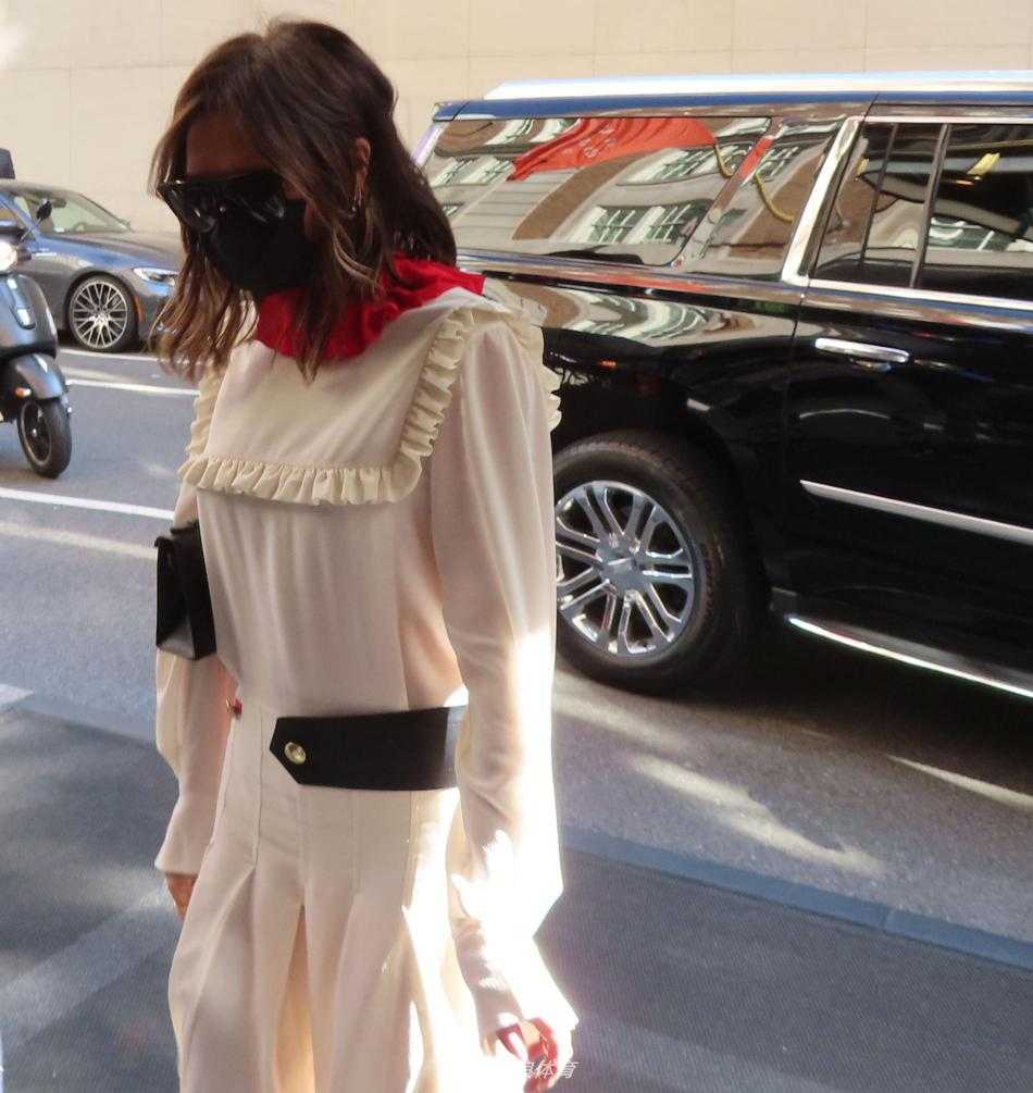 特写镜头下，维多利亚的白色长裙质地轻盈，收腰设计完美勾勒出她的模特般身材，即使只是一个转身的瞬间，也流露出毫不费力的高级时髦感。